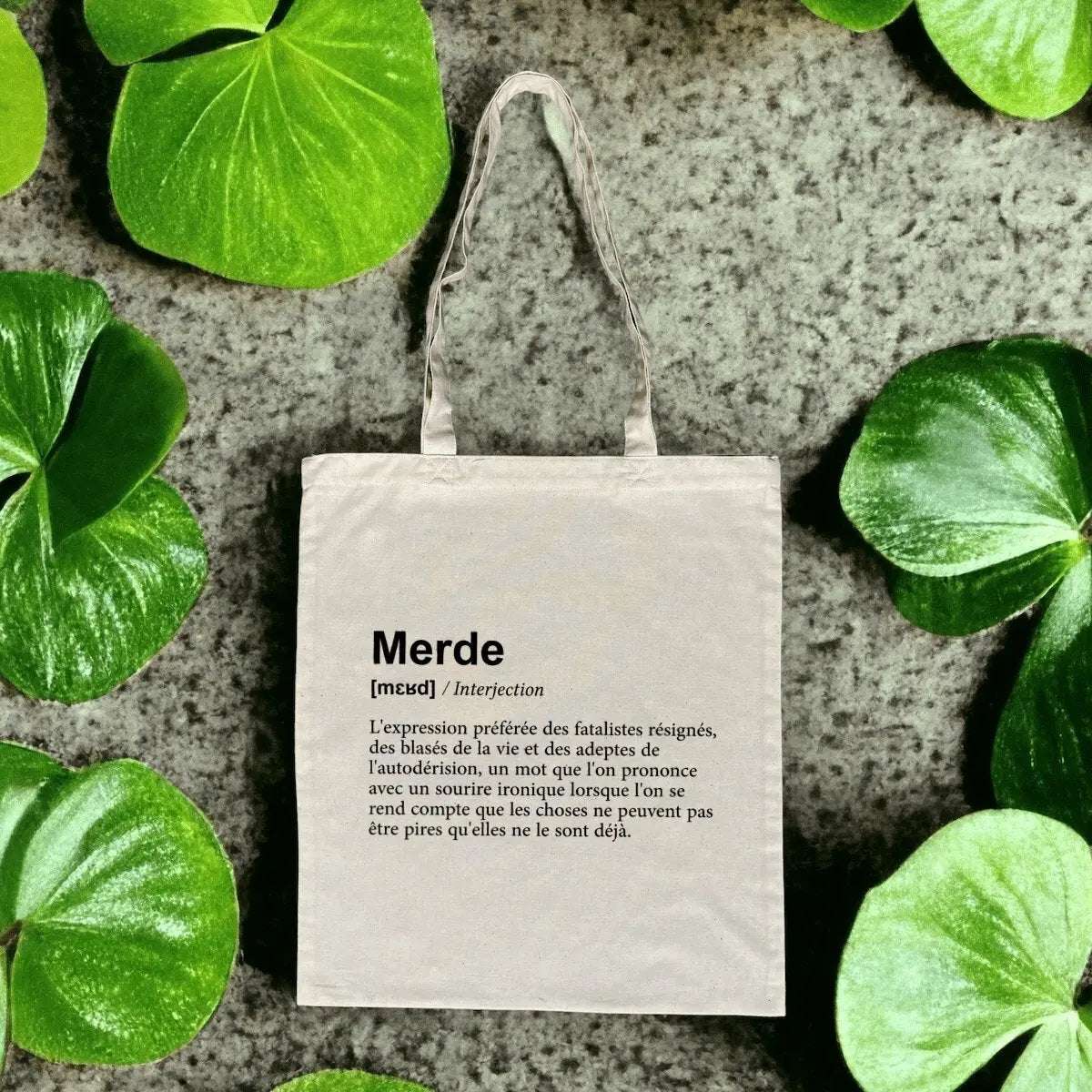 Totebag en coton biologique avec une impression humoristique façon dictionnaire de la définition du mot "merde", sac léger de 160 g, taille unique, esprit décalé et écologique.