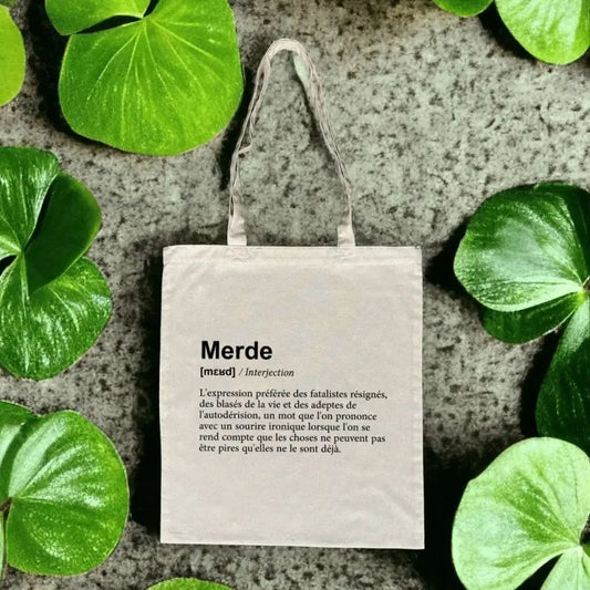 Totebag en coton biologique avec une impression humoristique façon dictionnaire de la définition du mot "merde", sac léger de 160 g, taille unique, esprit décalé et écologique.