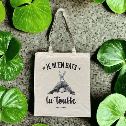 Totebag en coton biologique avec l’inscription humoristique "Je m'en bats la touffe", sac léger de 160 g, taille unique, style décalé et éco-responsable.