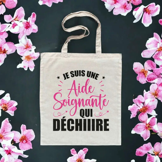 Totebag en coton biologique avec l’inscription "Je suis une aide-soignante qui déchire", sac léger de 160 g, taille unique, design engagé et éco-responsable.