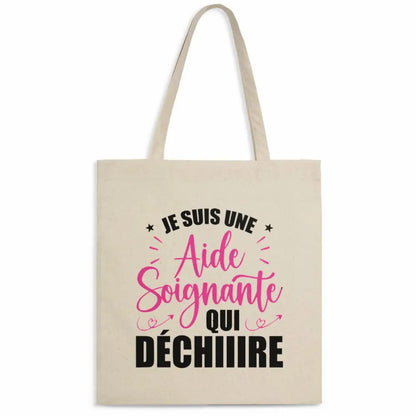 Totebag en coton biologique avec l’inscription "Je suis une aide-soignante qui déchire", sac léger de 160 g, taille unique, design engagé et éco-responsable.